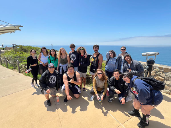 group of students by the Cabrillo lighthouse with ocean in background