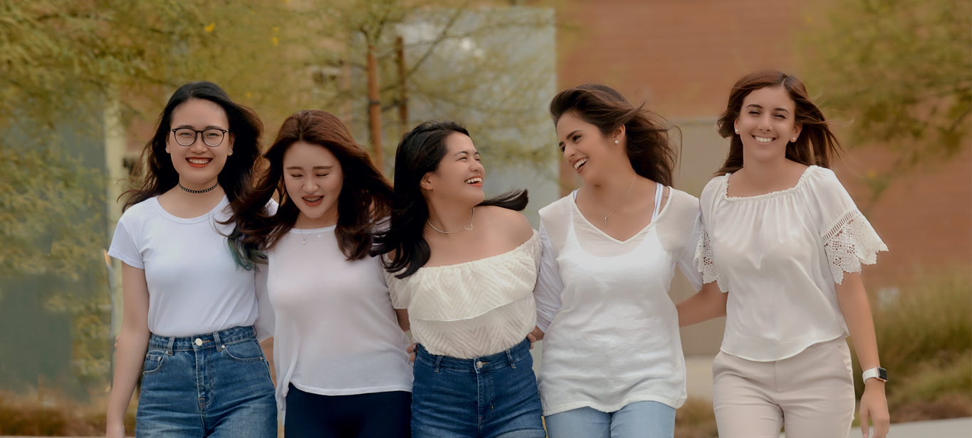 five international students laughing